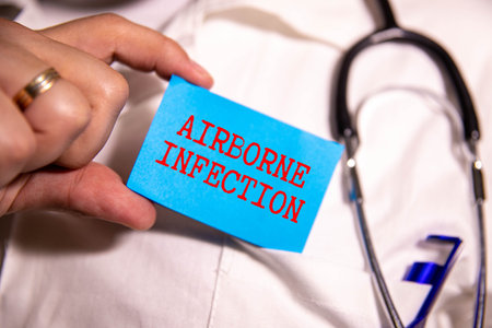 The words AIRBORNE INFECTION on a wooden cubes with a stethoscopeの写真素材