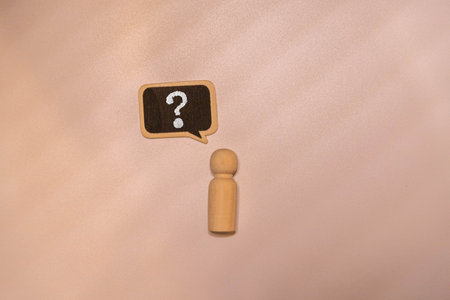 Wooden mannequin on a blue background with a question mark with space for copying text.の写真素材