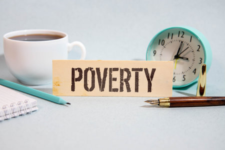Poverty word written on wood block. Poverty text on cement table for your design, concept.