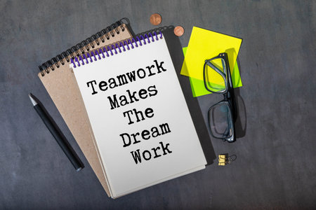 Wooden blocks with words 'Teamwork Makes the Dream Work'.