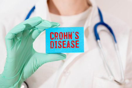Doctor holding a card with diagnosis words Crohn's disease. Healthcare medical concept.