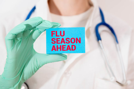 Doctor holding a pen and card with text flu season ahead, medical concept.の写真素材