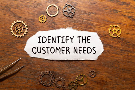 uncover your customer needs. Text on white paper on torn paper.の写真素材