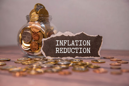 notepad ,chart and calculator. Top view text INFLATION REDUCTION