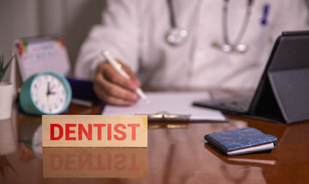 Banner for National Dentist's Day with hands holding mouth dental mirror and model of toothの写真素材