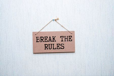 BREAK THE RULES text on yellow sticky on a keyboardの写真素材