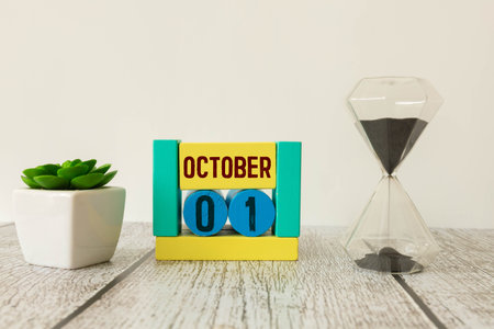 Vintage photo, October 1st. Date of 1 October on wooden cube calendar, copy space for text on board