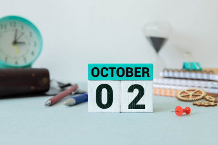 October 2 on a wooden calendar on a table or shelf.One day of the autumn month.Calendar for October. Autumnの写真素材