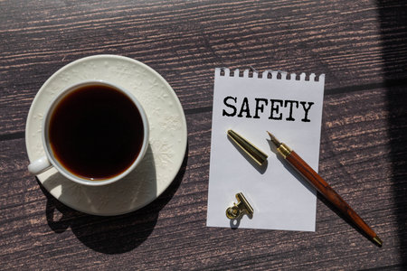 SAFETY text on notepad with calculator, money and pencil on the office desk. Business conceptの写真素材