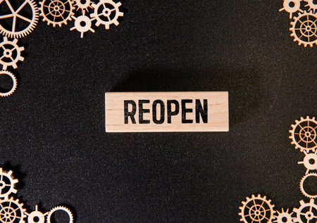 torn paper revealing the word REOPENING on white background