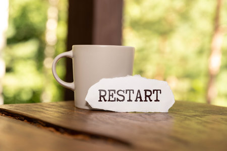 A row of wooden cubes with restart text on the table. New beginning of life, business or career conceptの写真素材