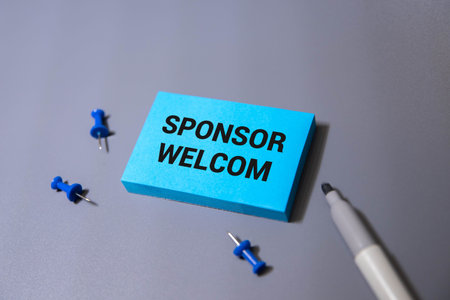 Yellow sticker on the dark gray texture background with text Sponsors Welcome. Concept photo