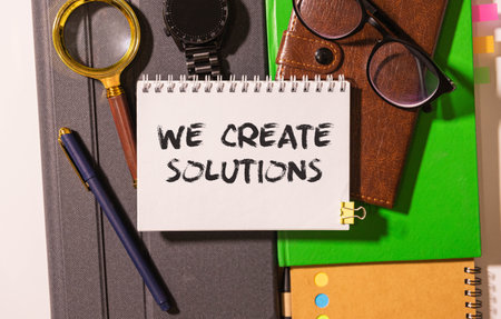 text text We create solutions appearing behind torn brown paper.の写真素材