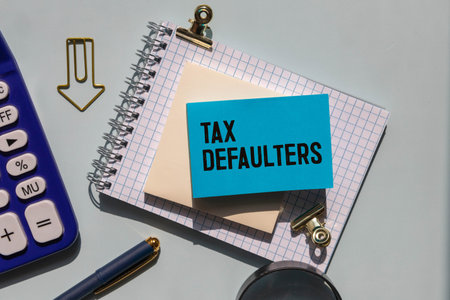tax defaulters word under torn black paper.