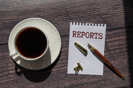 WEEKLY REPORT text on yellow sticky on a board background.の写真素材