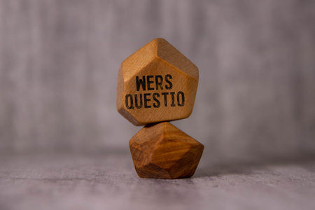 On a wooden table are two wooden blocks with the text question.の写真素材