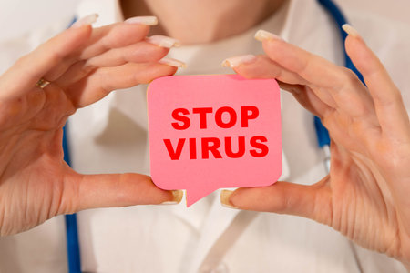 On the table are pills, a stethoscope, a cardiogram and a sign that says - STOP VIRUS. The concept...