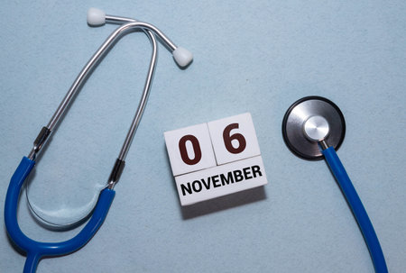 6 November on wooden gray cubes. Calendar cube date 06 November. Concept of date. Copy space for text or event. Educational cubes. Wood blocks in box with date, day and month. Selective focusの写真素材