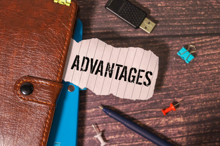 Advantages symbol. Concept word Advantages on beautiful black tablet. Beautiful wooden table white...