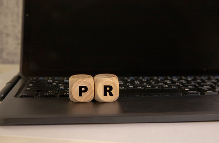 PR - Public Relations symbol. Concept word PR on wooden cubes.の写真素材