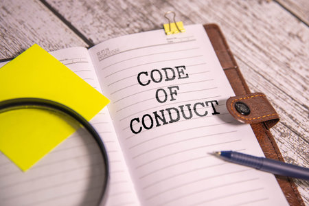 Business and code of conduct concept. Copy space. Code of conduct symbol written through a...