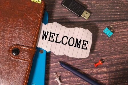 WELCOME symbol. Copy space. Concept word WELCOME on wooden blocks with yellow background.の写真素材