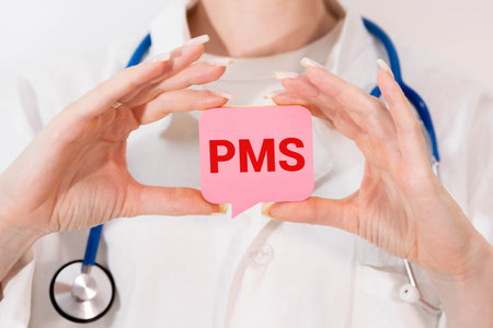 Medical and PMS, premenstrual syndrome symbol. White card with the word PMS.
