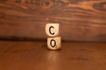 Net-zero emissions in 2050. Save the earth and environment, and be carbon neutral. Wooden cubes with eco-friendly icons on a green background. World Earth Day conceptの写真素材