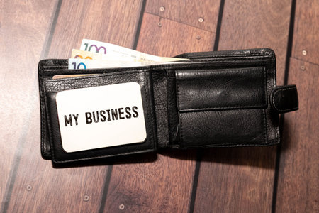 Conceptual words THIS IS STORY on a blank page of a business notebook through a magnifying glass, a...
