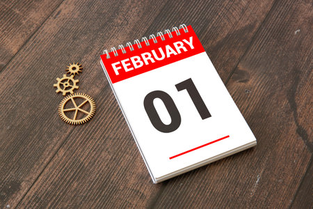 Wooden block calendar with date February 01 on pink blue backround. Top view. Flat layの写真素材