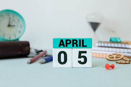 April 5th. Image of april 5 wooden color calendar on white background. Spring day, empty space for textの写真素材