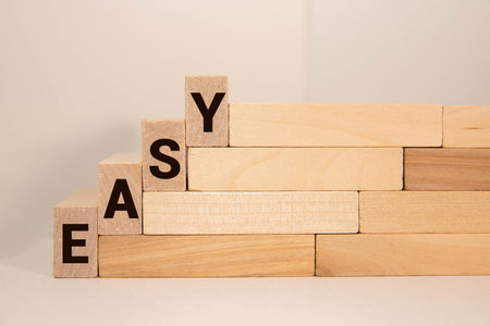 Keep it Simple symbol. Concept words Keep it Simple on wooden blocks. Businessman hand. Beautiful deep blue background with succulent plant. Business and Keep it Simple concept. Copy space.の写真素材