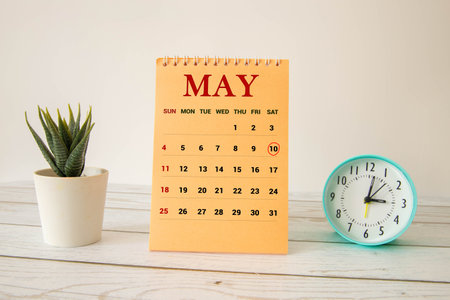 Wooden block calendar with date May 10 on a concrete background with pebblesの写真素材