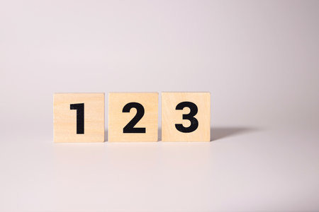 Stacked wooden blocks with numbers from 1 to 5 isolated on white backgroundの写真素材