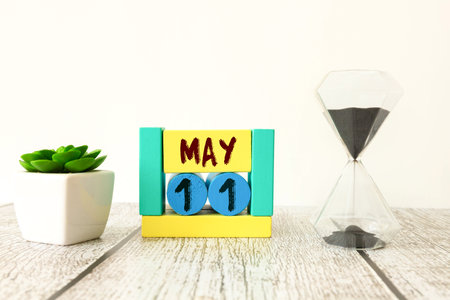 11 May text on wooden blocks with customizable space for text or messages. Month and copy space concept.の写真素材
