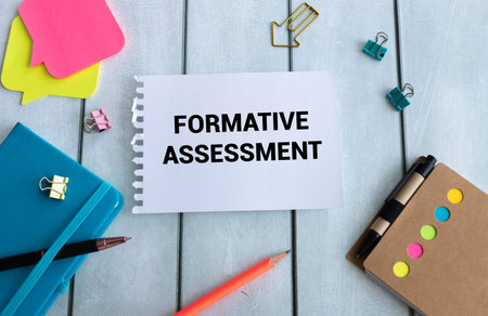 Formative Assessment text on a sheet of notepad near a cup of coffee