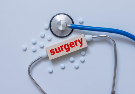 Stethoscope, pills and notebook with SURGERY word on medical desk.の写真素材