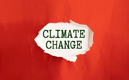 A small notebook with the text "Climate Change" in it. It is a striking picture.の写真素材