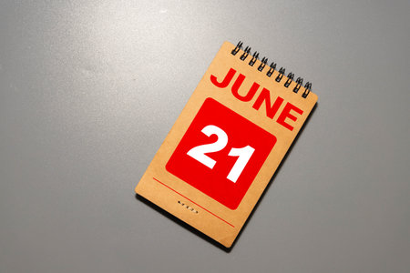 Wooden block calendar with date June 21 on white concrete backgroundの写真素材