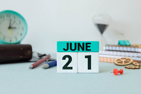 Wooden block calendar with date June 21 on white concrete backgroundの写真素材