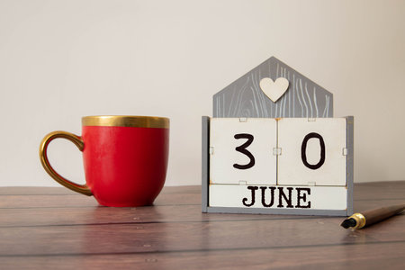 June 30th.June 30 white wooden calendar on vintage wood abstract background. Summer day.Copyspace...
