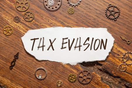 Tax Evasion Text on The Diary Paper for Writing on Gray Background.