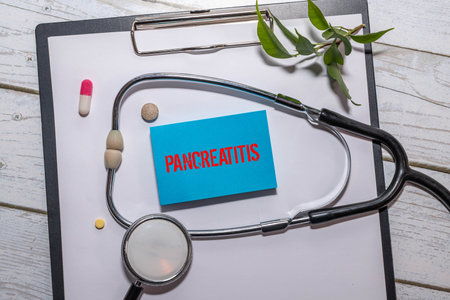 Medical Concept-Pancreatic cancer written on label tag with Stethoscope on wood backgroundの写真素材
