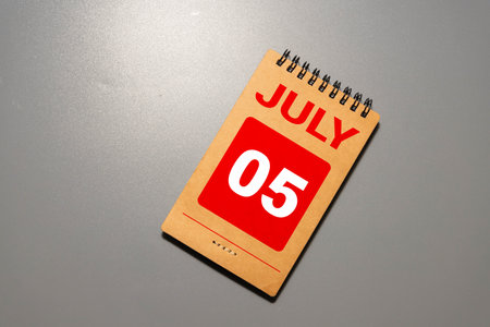 July 5 calendar date text on wooden blocks with blurred background park. Copy space and calendar conceptの写真素材