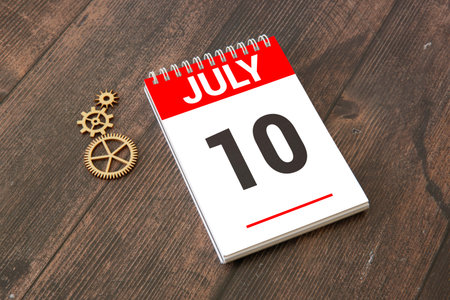 Vintage photo, July 10th. Date of 10 July on wooden cube calendar, copy space for text on board