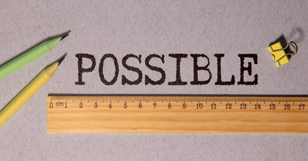 The word 'possible' is written in charcoal on a gray background. A ruler is placed under the word...