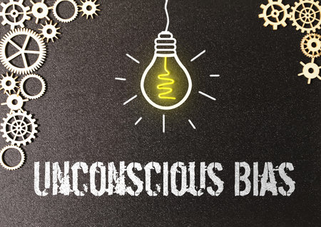 Unconscious bias words written on ripped paper with orange background. Conceptual unconscious bias...
