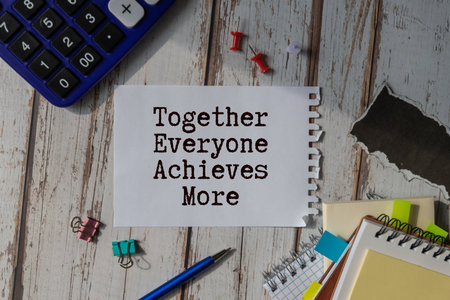 Together everyone achieves more phrase written with a typewriter.の写真素材