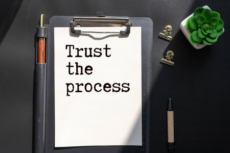 Stock image of crumpled paper balls around a spiral note book, Trust the process, Patience concept backgroundの写真素材