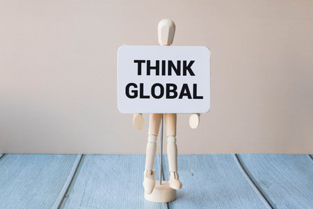 Think global act local symbol. Wooden blocks with words Think global act local. Beautiful gray...
